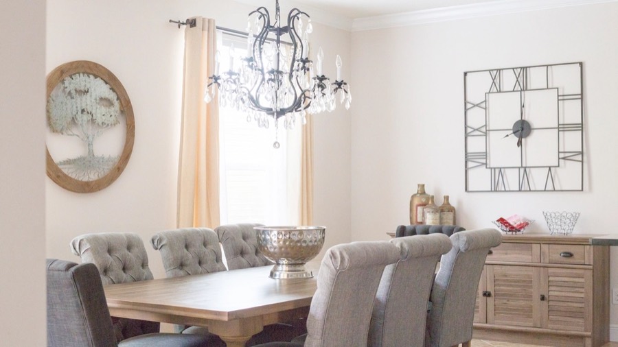 A dining room before redesign, with pale walls and a plain painted table