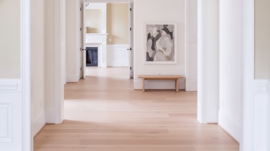 The same hallway redesigned into a minimalist hallway in chalk white with pale oak and a single artwork