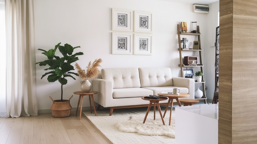 The same living room redesigned into a warm Scandinavian room with a boucle sofa, oak floor and layered rug