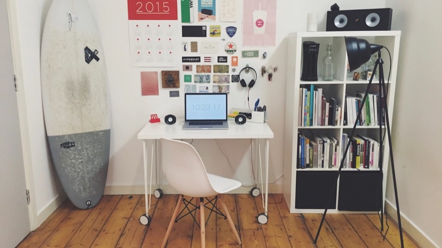 A home office before redesign, with grey office carpet and a cheap laminate desk