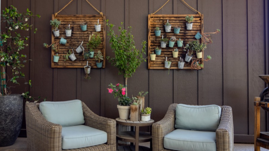A outdoor before redesign, with a plain grey patio with dated wicker seating